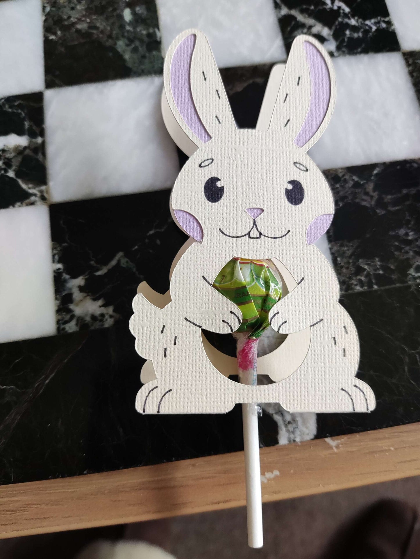 Bunny lollipop holder on a table, perfect for Easter treats and decorations.